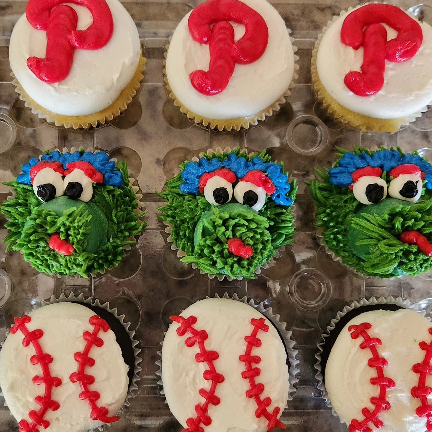 Nine decorated cupcakes with themed designs including numbers and characters