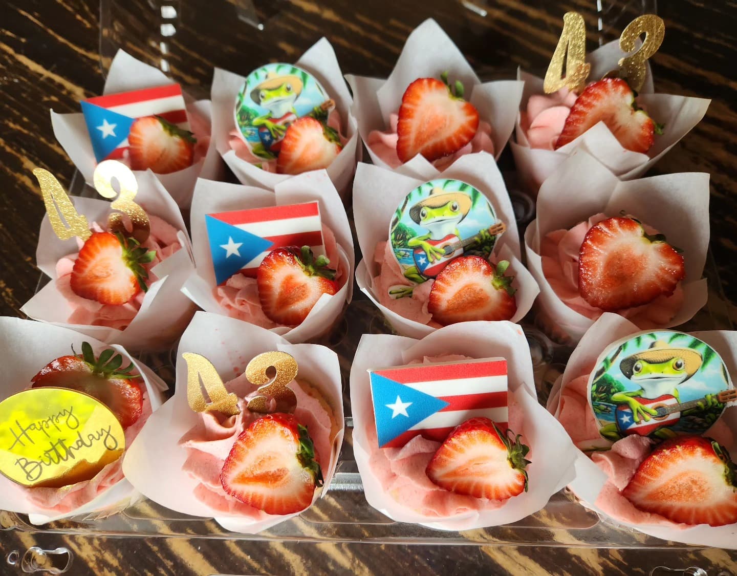 Chocolate-dipped strawberries in white paper cones with decorations