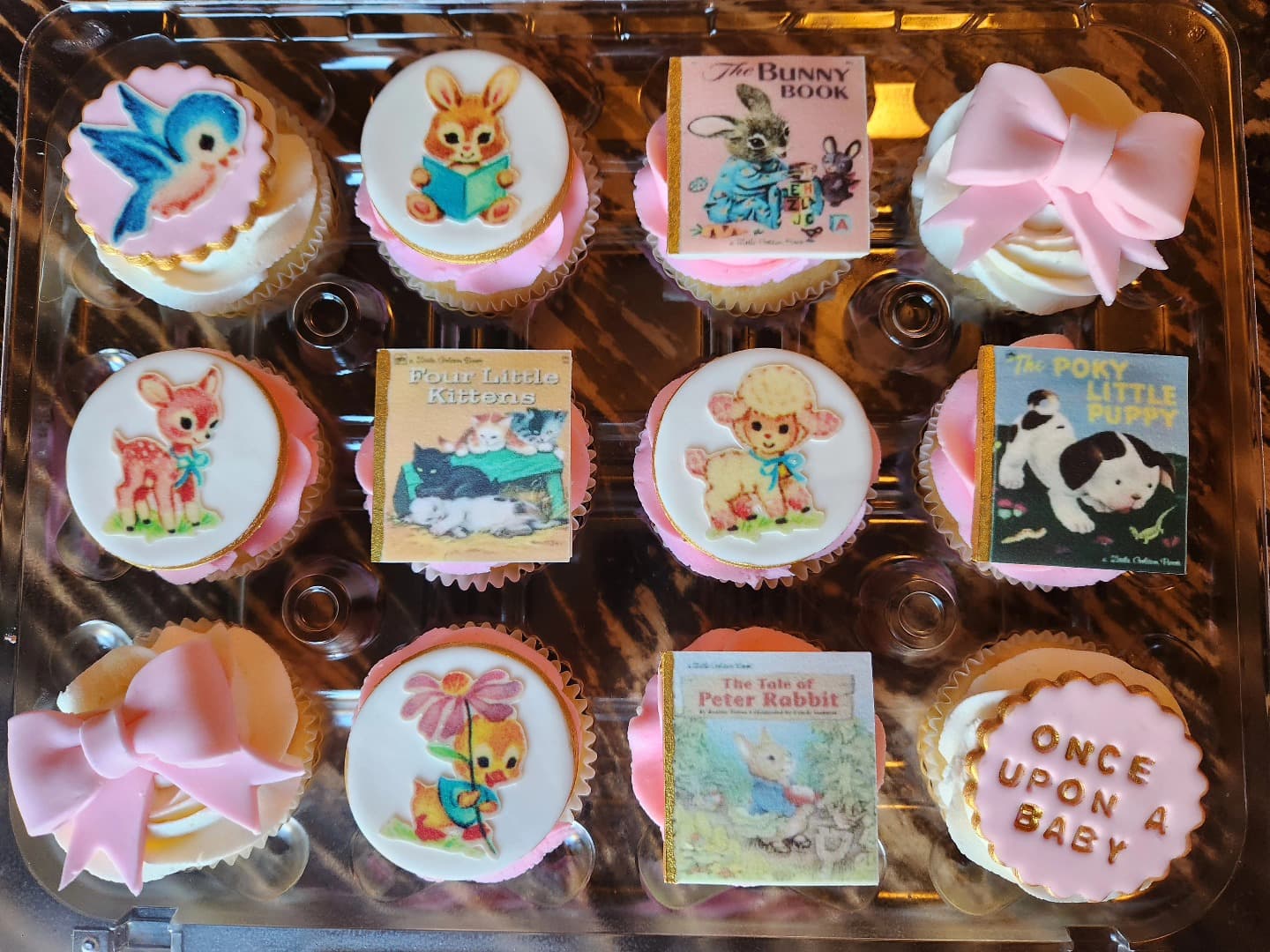 Box of assorted decorated cookies and cupcakes with themed designs