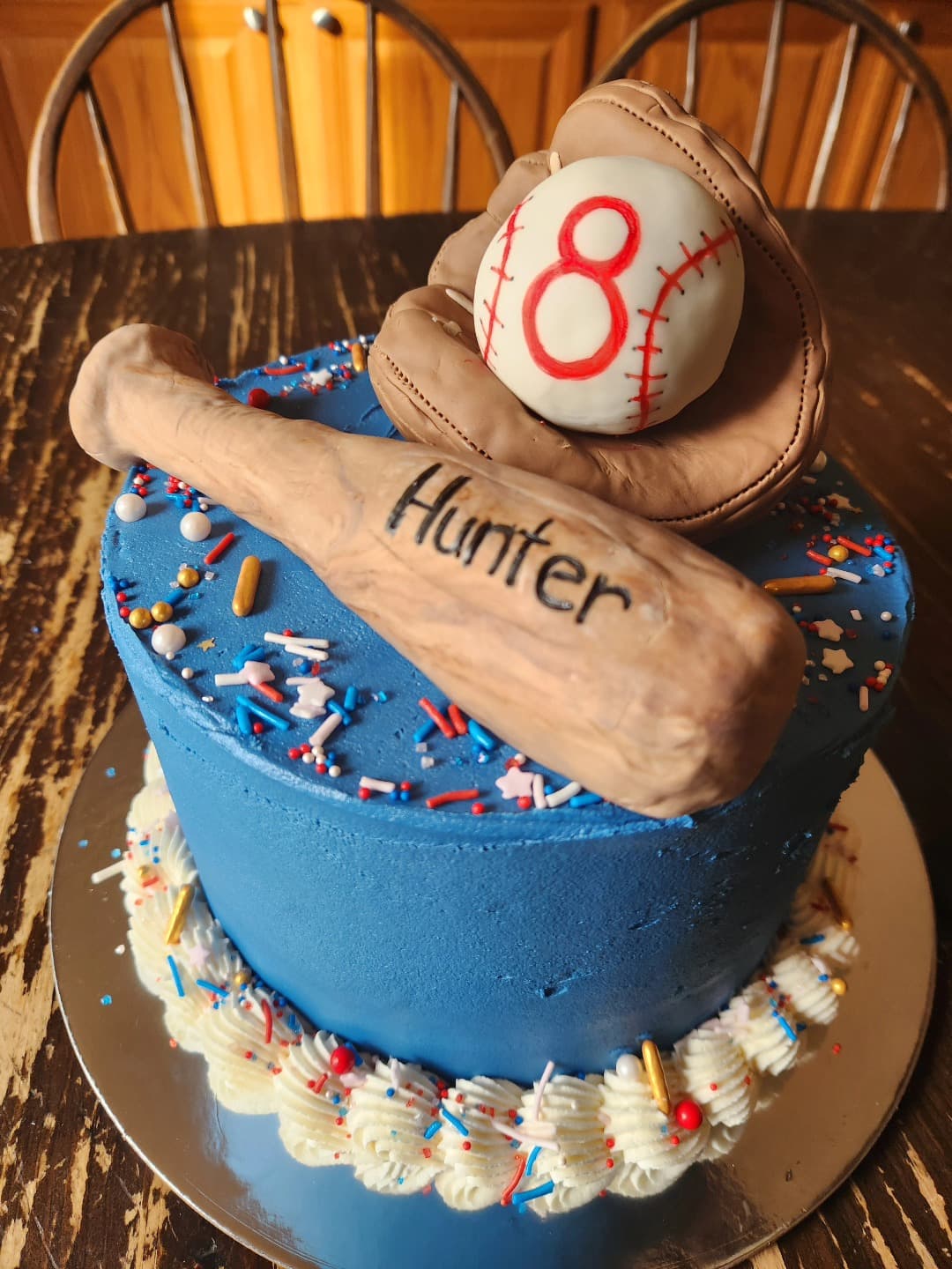Blue layered cake with baseball theme decorations